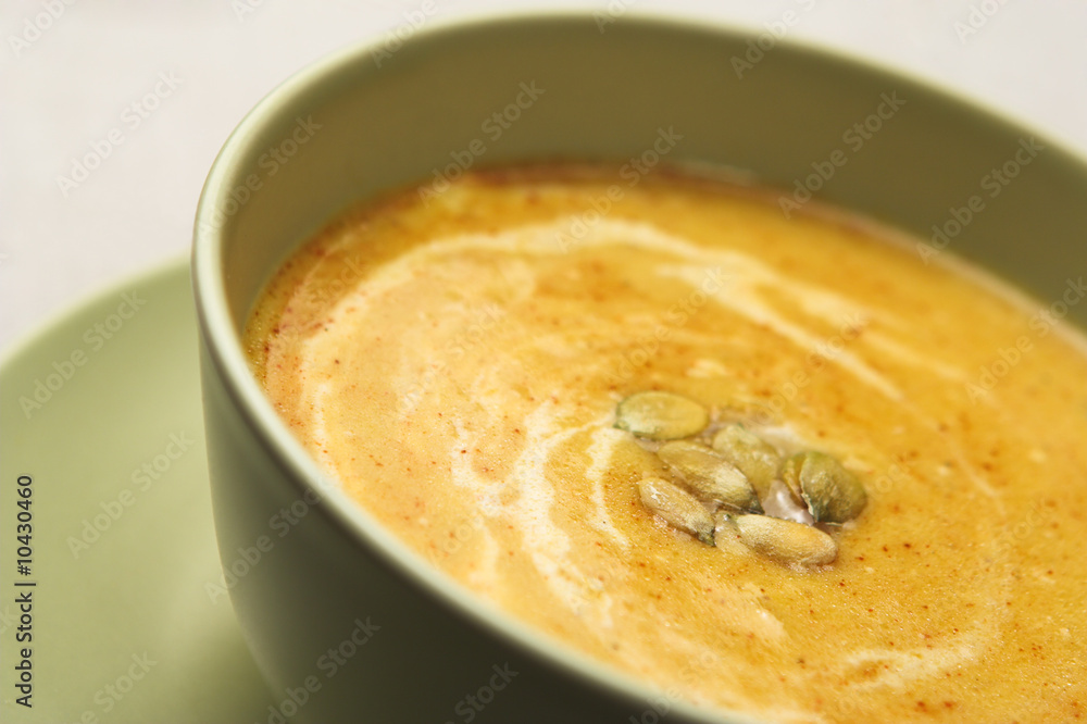 A bowl of pumpkin soup, shallow dof, focus is on seeds. A bowl of pumpkin soup, shallow dof, focus is on seeds.