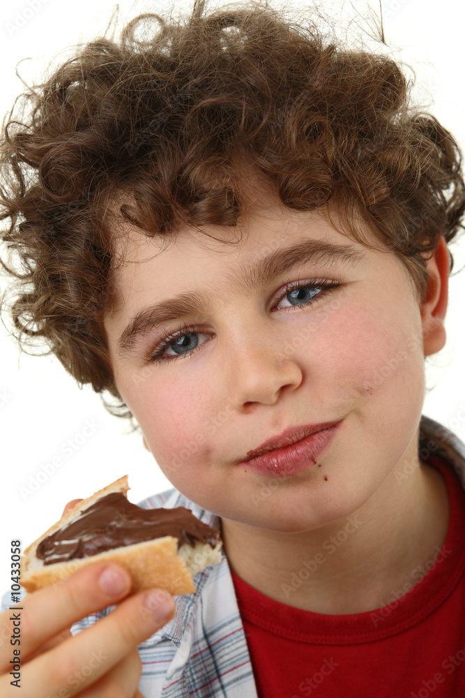Boy eating bread with peanut butter Boy eating bread with peanut butter