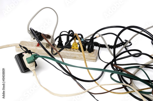 Tablou pe pânză Dirty old power strip overloaded with too many cords