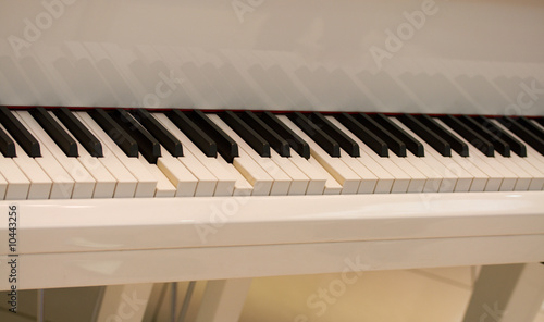 close-up self playing white piano keys