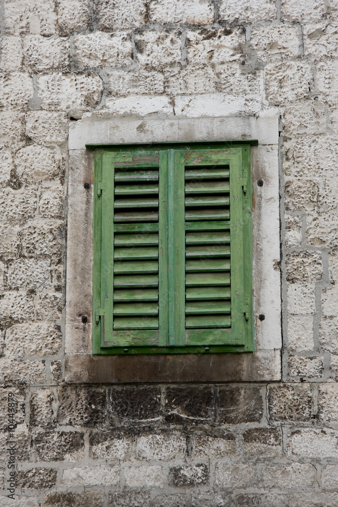 green window on stone house