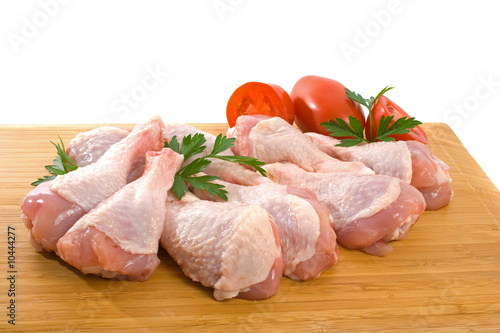 Fresh raw chicken wings on chopping board