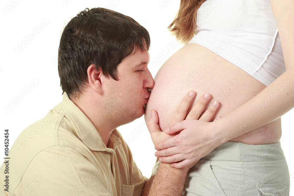 Man kissing belly of his wife