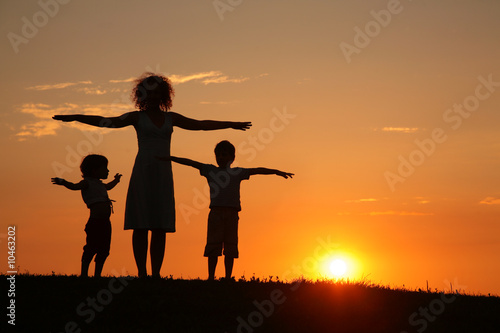 Mother and children on sunset sport training