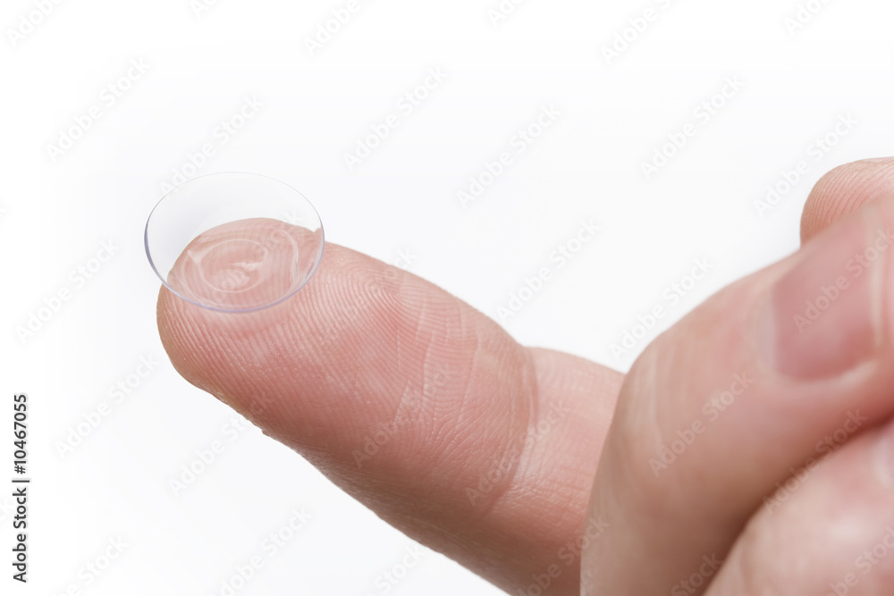 finger holding contact lens over white background finger holding contact lens over white background