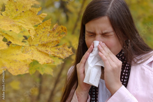 Photos teenage girl sneeze into handkerchief with maple leaf