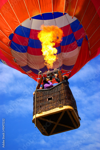 Colorful hot air balloon with bright burning flame