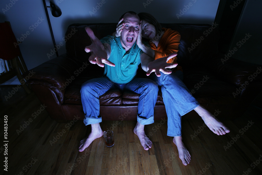 Fototapeta premium Husband and wife watching TV at home