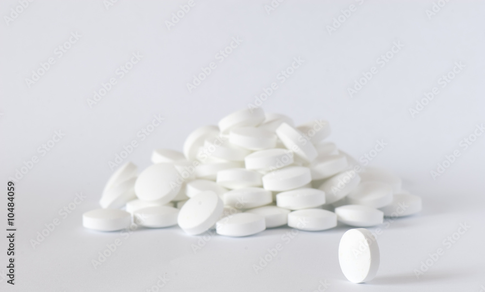 white round vitamins on the white isolated background