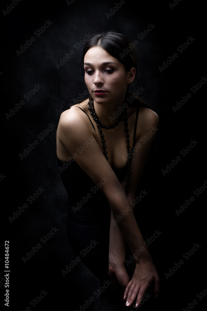Fototapeta premium young elegant woman, studio dark background