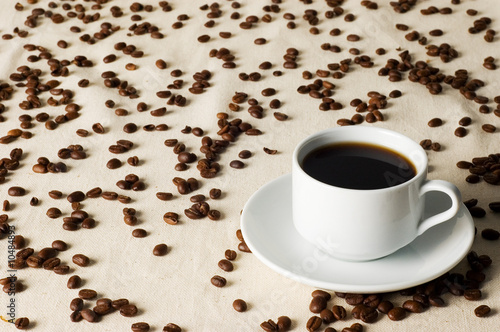 white cup of coffee and coffee grains