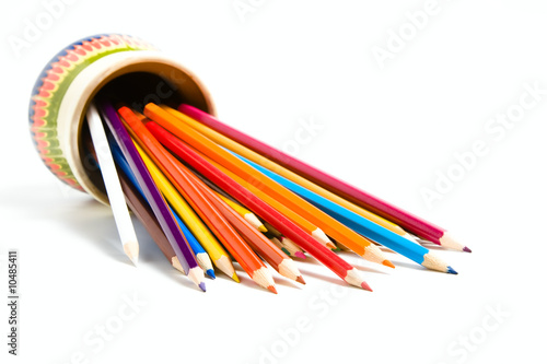 Assortment of colored pencils with shadow on white background
