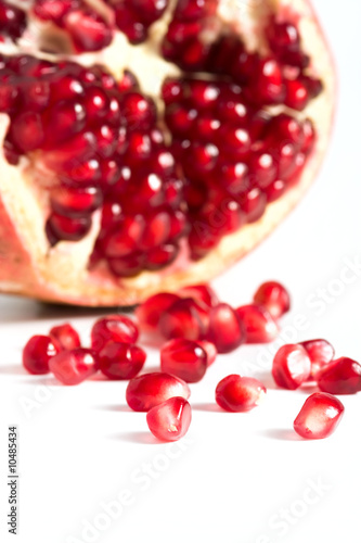 Pomegranates seeds against white