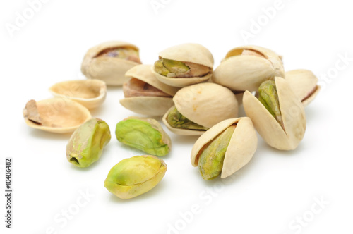 Heap of pistachios nuts in isolated white background