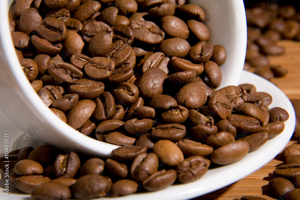 Cup with coffee grain, costing on coffee grain Cup with coffee grain, costing on coffee grain