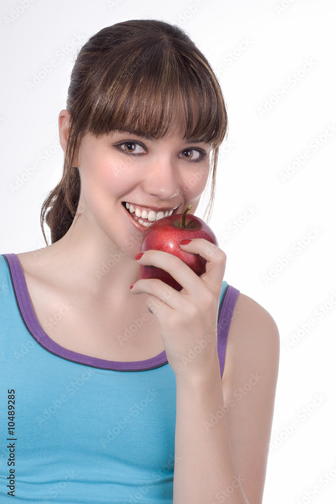 Beautiful young woman smiling holding a red apple Beautiful young woman smiling holding a red apple