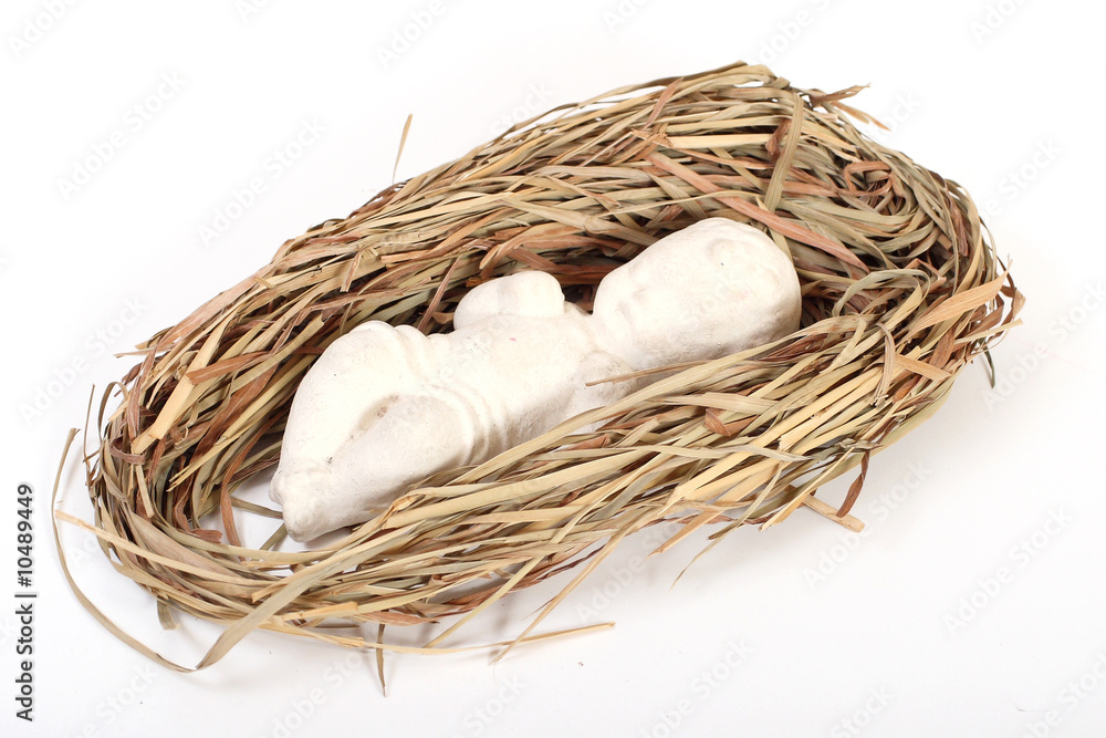 Christmas scene: baby Jesus figurine lying on hay