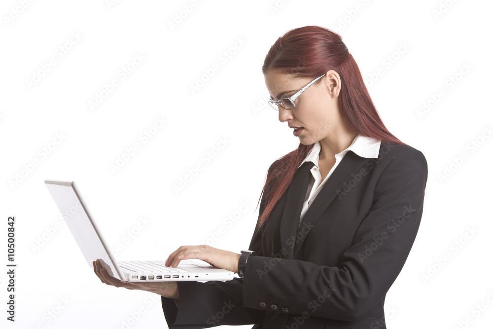 Business woman standing up working on a laptop computer Business woman standing up working on a laptop computer
