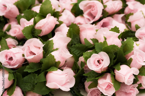 Large bouquet of pink roses with green leaves