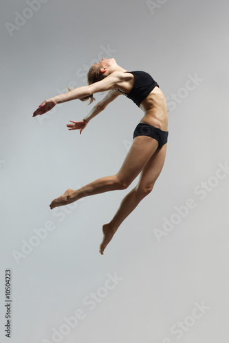 young and beautiful female jumping high