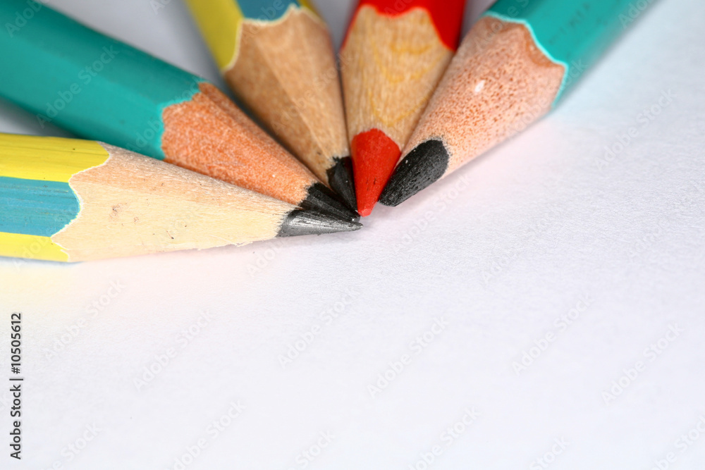 Closeup image of pencils laying on white paper Closeup image of pencils laying on white paper