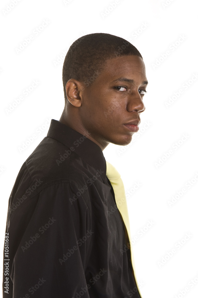 Obraz premium A young black man wearing black suit and yellow tie on white