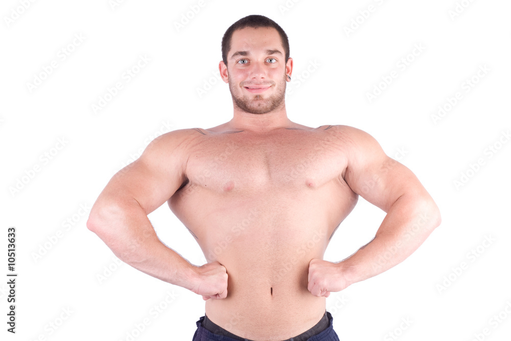 young bodybulider posing in front of white background