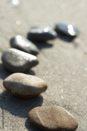Stones on sand at the sea, a pebble
