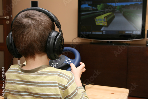 Boy with computer steering wheel