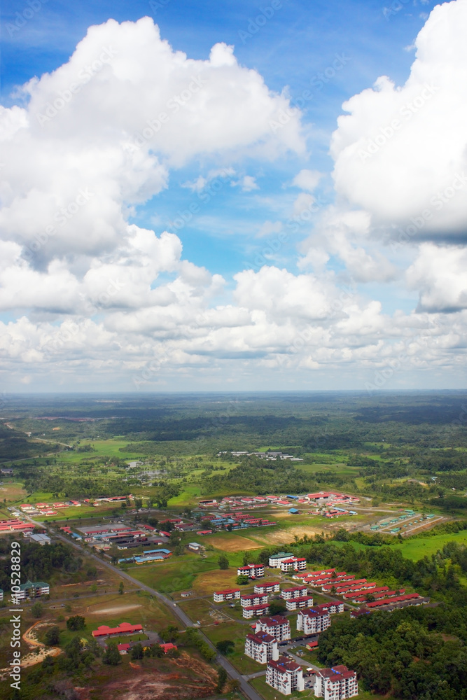 Aerial view of cloud over river and residential area.