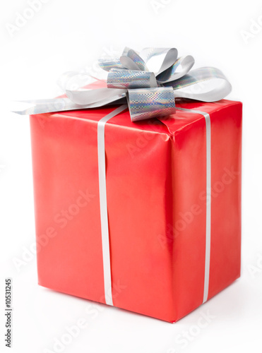 Isolated gift in red decorative box bound with silver ribbon © pressmaster