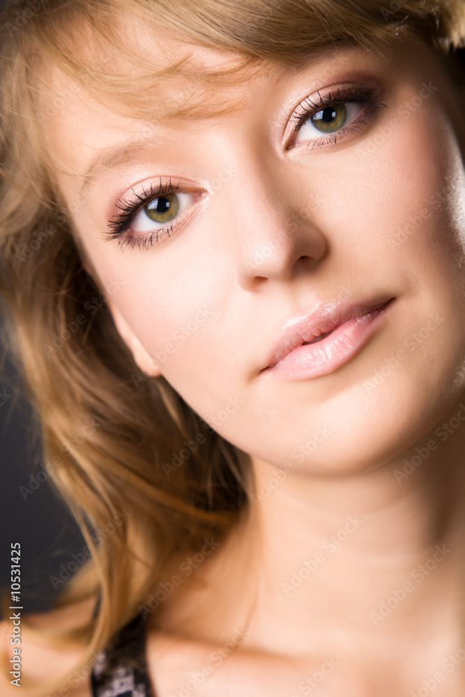 Young woman portrait. On dark background. Young woman portrait. On dark background.