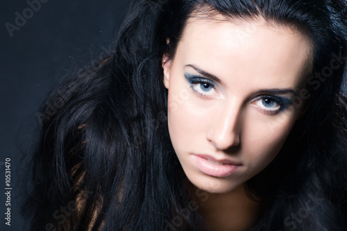 Wallpaper Mural Young brunette woman portrait. On dark background. Torontodigital.ca