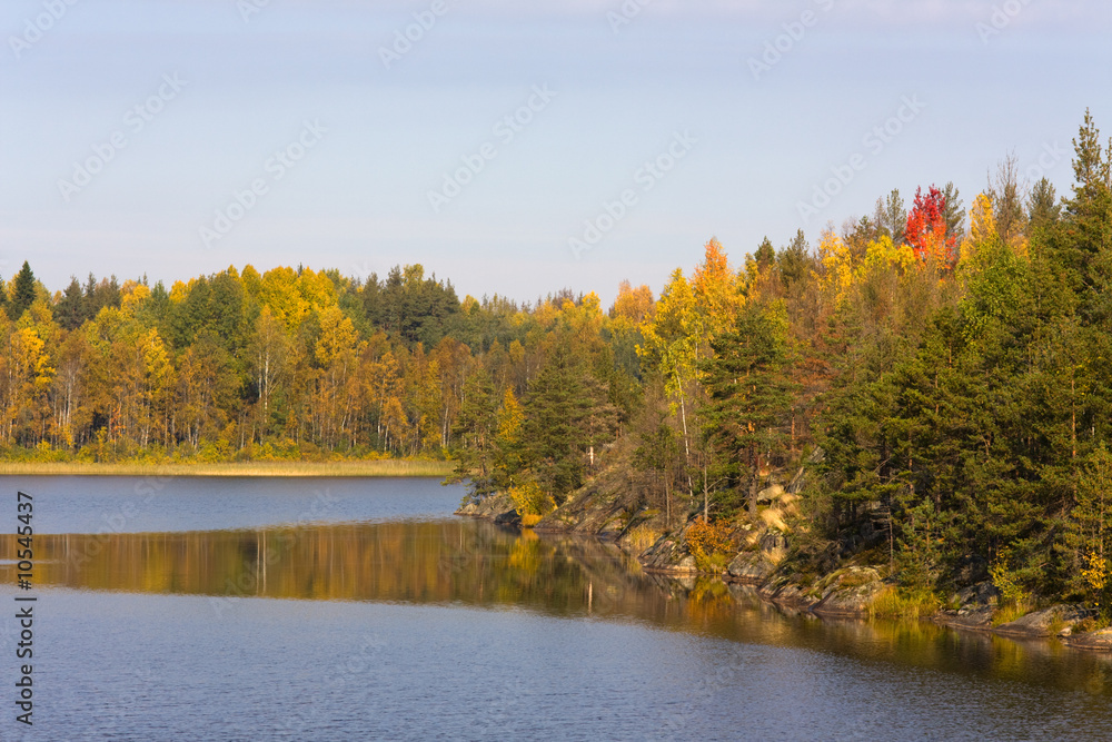 Rocky coast of wood lake in the autumn