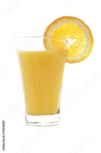 Orange juice reflected on white background. Shallow DOF