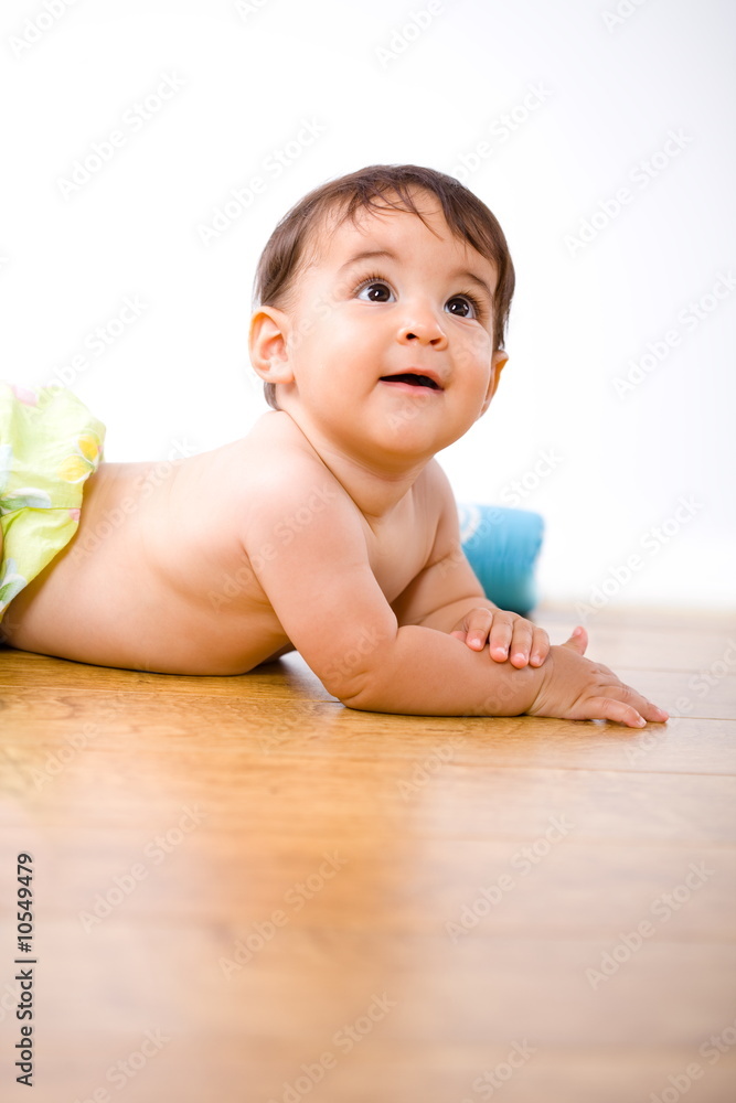 Cute 8 months old baby belly-band on hardwood floor. Cute 8 months old baby belly-band on hardwood floor.