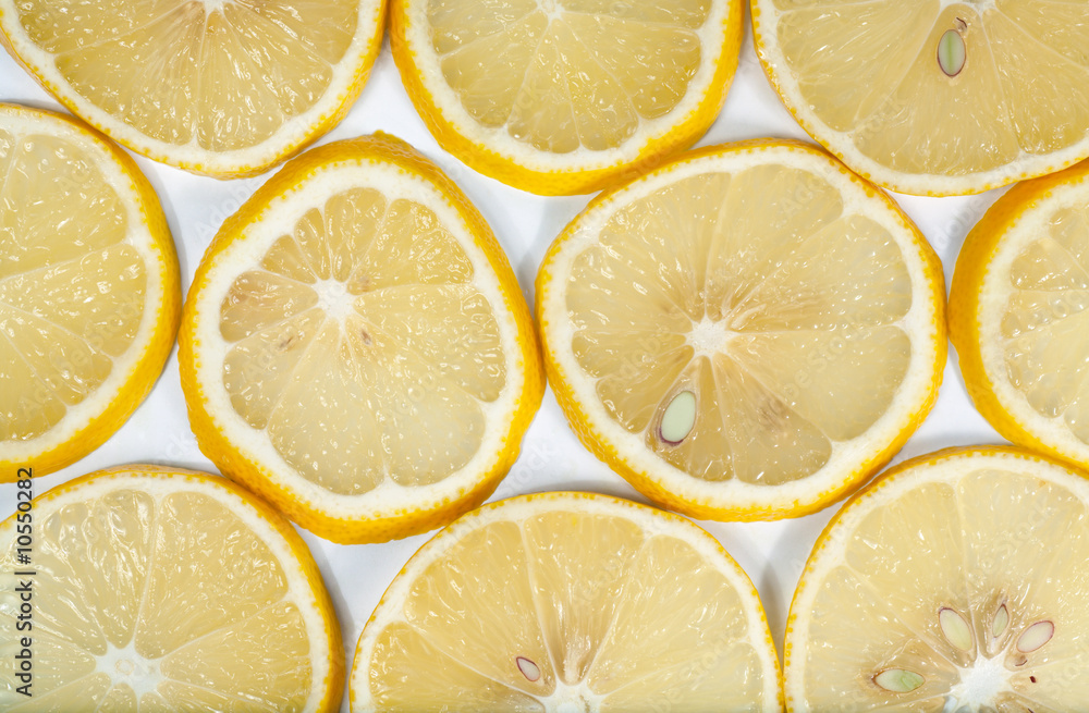 Yellow lemon macro sliced cuts on light background Yellow lemon macro sliced cuts on light background