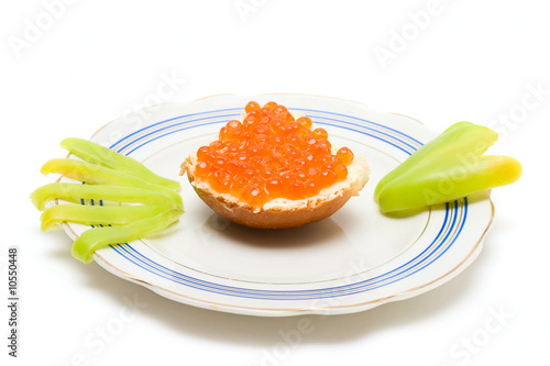 Sandwich with red caviar on plate isolated on white