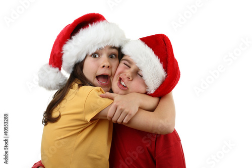 Kids wearing Santa Claus hats isolated on white background
