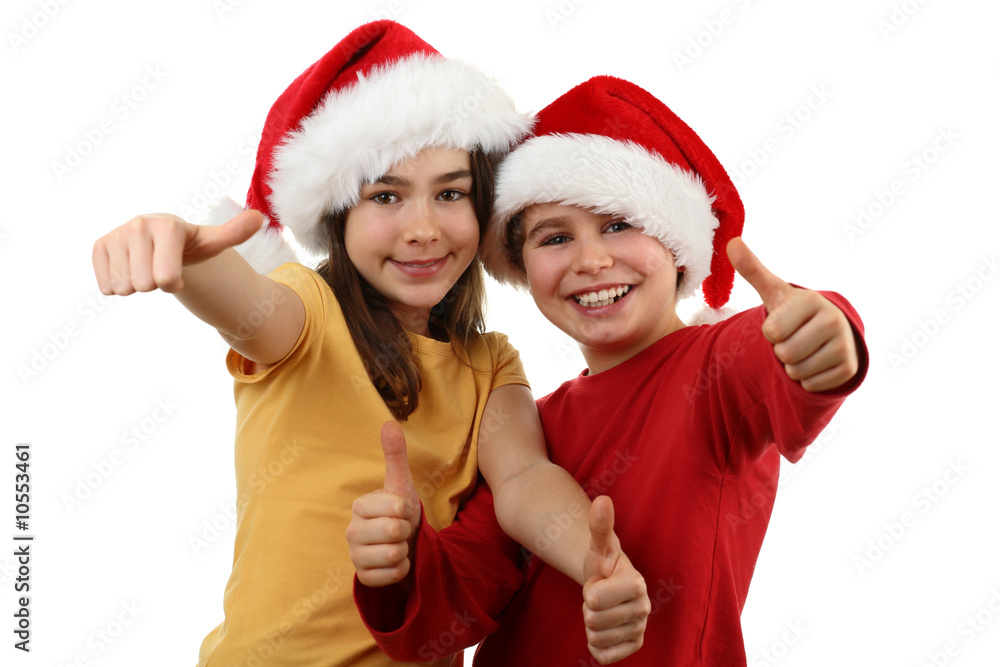 Kids wearing Santa Claus hats showing OK sign , isolated Kids wearing Santa Claus hats showing OK sign , isolated