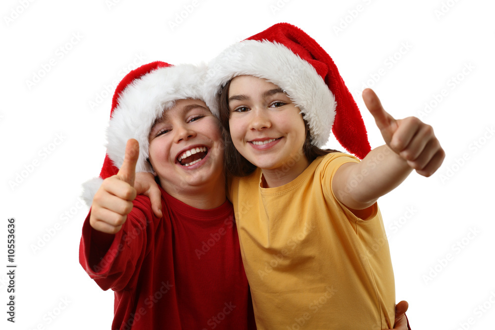 Kids wearing Santa Claus hats showing OK sign , isolated Kids wearing Santa Claus hats showing OK sign , isolated