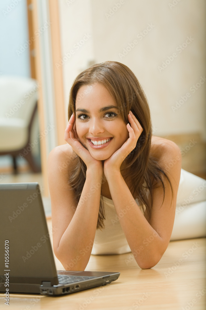 Portrait of young happy woman with laptop at home Portrait of young happy woman with laptop at home