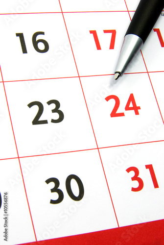 Detail view of a typical calendar with a pen.