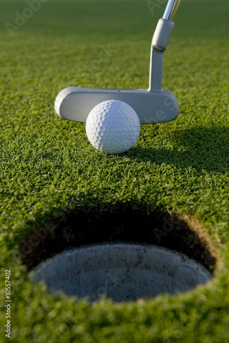 A short put in the game of golf with a ball and a putter