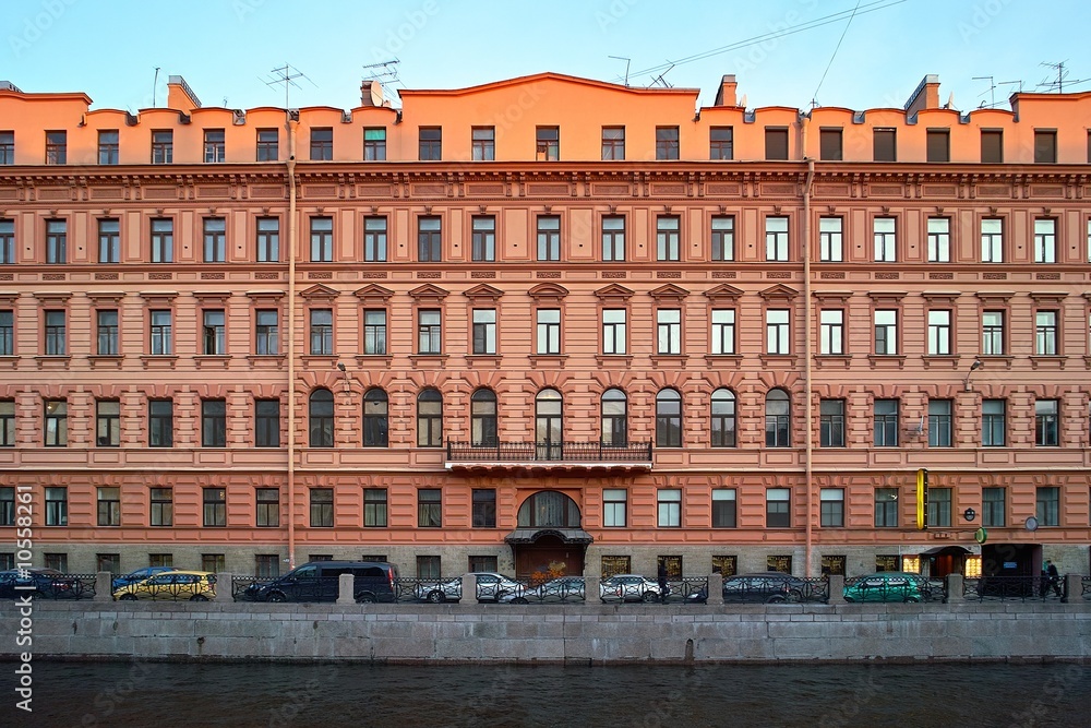 Great old red building on the river quay in Saint Petersburg