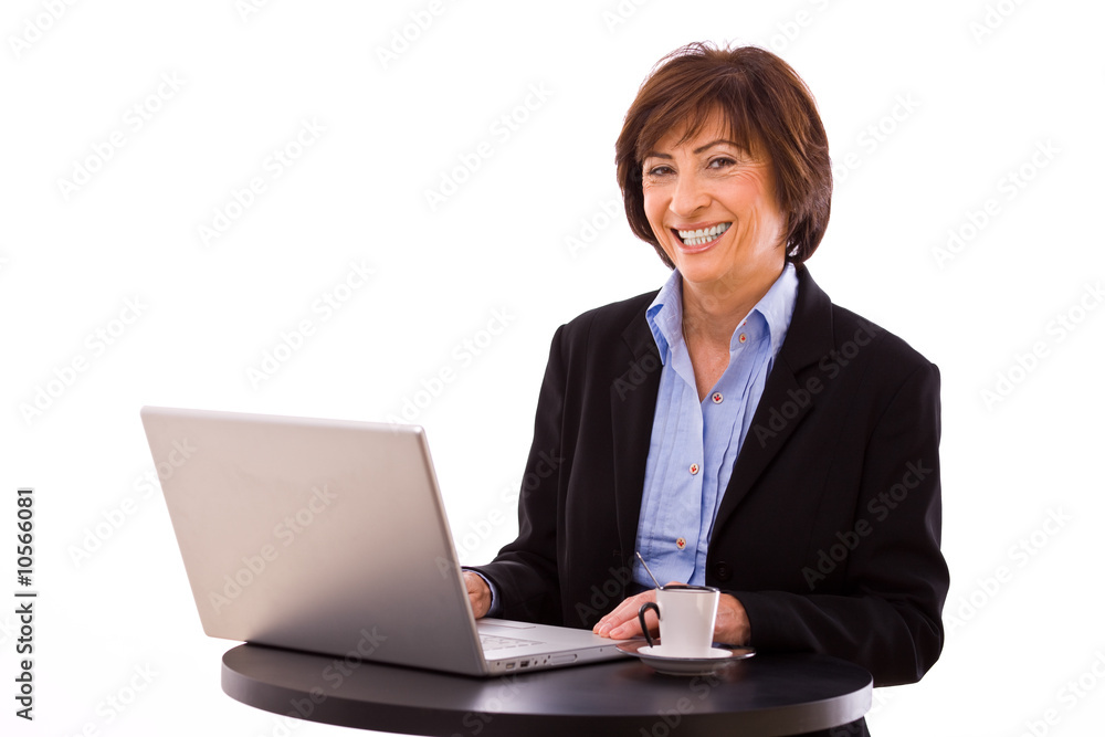 Senior businesswoman working on laptop computer Senior businesswoman working on laptop computer