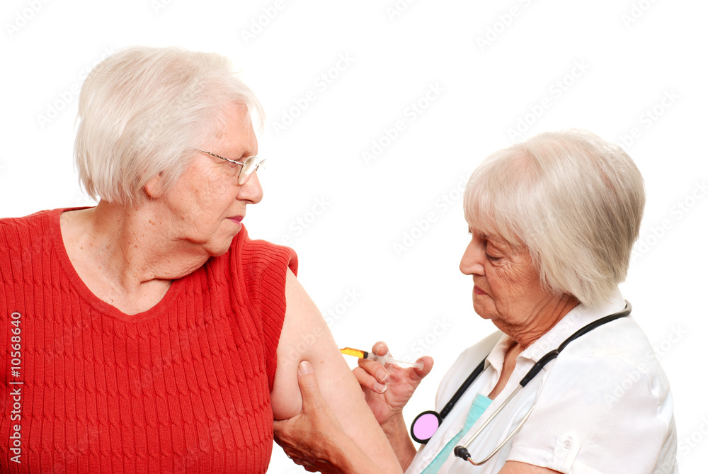 Senior doctor giving an elderly patient her injection Senior doctor giving an elderly patient her injection