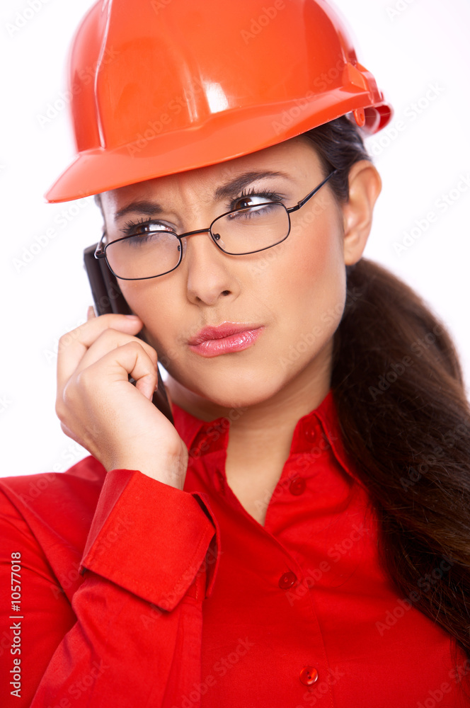 Female architect talking cell phone, isolated on white Female architect talking cell phone, isolated on white