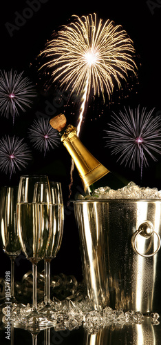 Glasses of champagne with fireworks