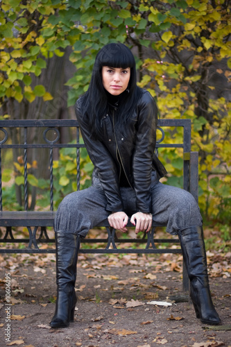 beautiful fashion brunette girl on the bench